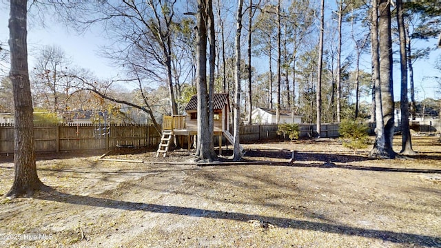 view of yard with a playground and fence