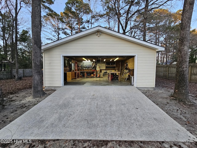 detached garage featuring fence