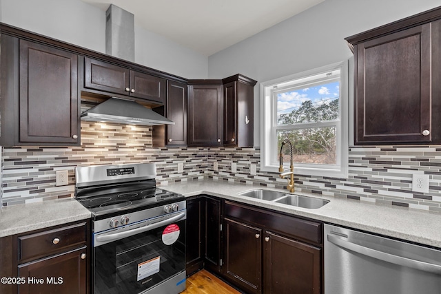 126 Lightwater Dr, Aberdeen, NC 28315 - kitchen featuring decorative backsplash, appliances with stainless steel finishes, dark brown cabinets, a sink, and under cabinet range hood