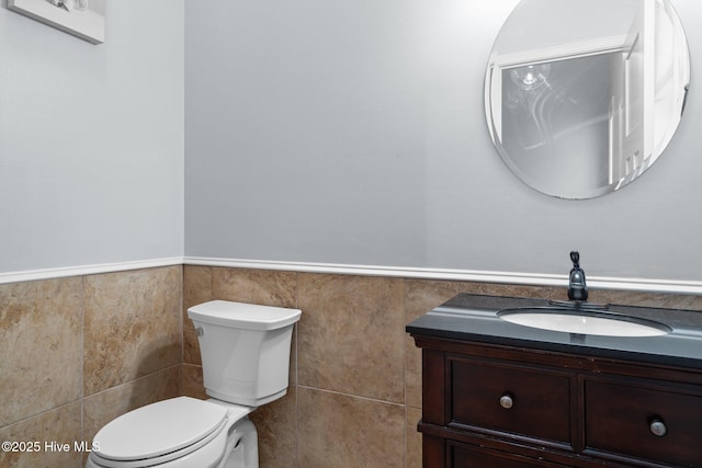 126 Lightwater Dr, Aberdeen, NC 28315 - bathroom featuring vanity, toilet, tile walls, and a wainscoted wall