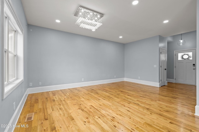 126 Lightwater Dr, Aberdeen, NC 28315 - spare room featuring a chandelier, light wood-style flooring, recessed lighting, baseboards, and visible vents