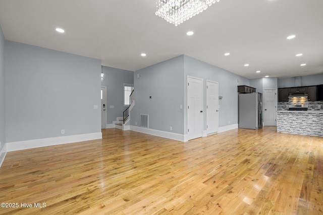 126 Lightwater Dr, Aberdeen, NC 28315 - unfurnished living room featuring stairs, recessed lighting, baseboards, and light wood-type flooring