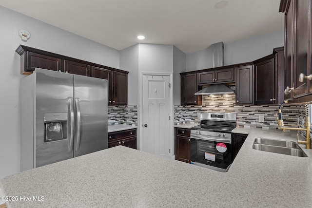 126 Lightwater Dr, Aberdeen, NC 28315 - kitchen with decorative backsplash, dark brown cabinets, a sink, under cabinet range hood, and stainless steel appliances