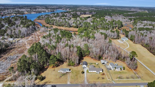 drone / aerial view with a forest view and a water view