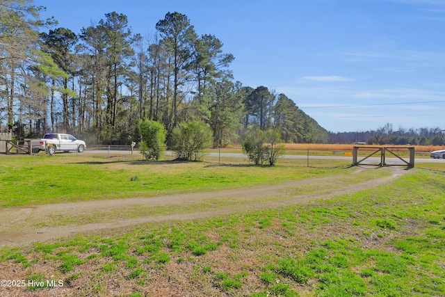 view of yard with a rural view and fence