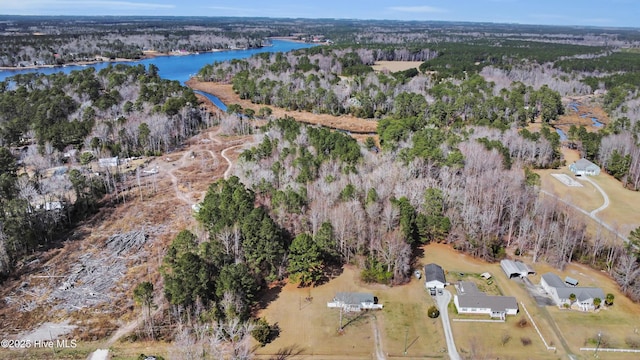 aerial view featuring a wooded view and a water view