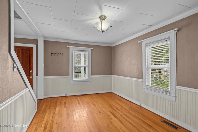 209 N 8th St, Morehead City, NC 28557 - empty room featuring light wood-style flooring, wainscoting, and ornamental molding