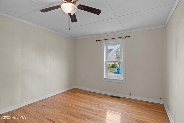 209 N 8th St, Morehead City, NC 28557 - empty room with light wood finished floors, baseboards, a ceiling fan, and ornamental molding