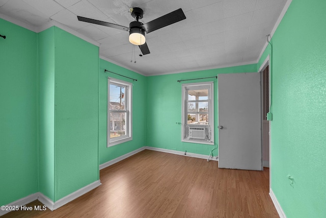 209 N 8th St, Morehead City, NC 28557 - empty room with crown molding, wood finished floors, cooling unit, ceiling fan, and baseboards