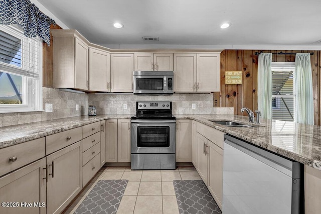 kitchen featuring visible vents, backsplash, appliances with stainless steel finishes, and a sink