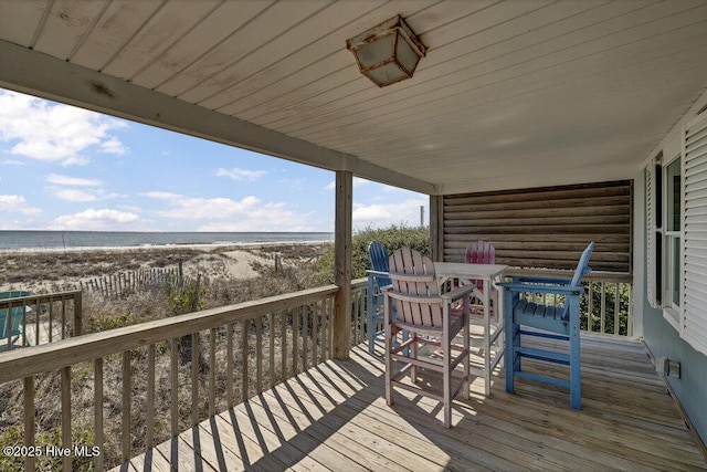 wooden terrace with a view of the beach