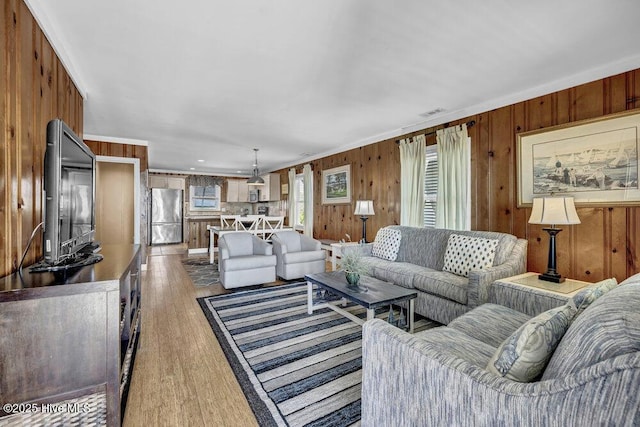 613 N Anderson Blvd, Topsail Beach, NC 28445 - living area featuring wooden walls, visible vents, and wood finished floors