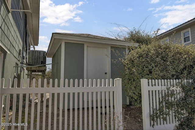 exterior space with central air condition unit and fence