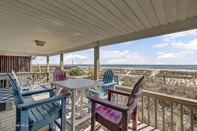 deck with a water view and a beach view