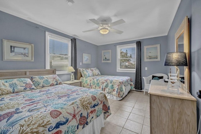 bedroom with ceiling fan, light tile patterned flooring, and ornamental molding