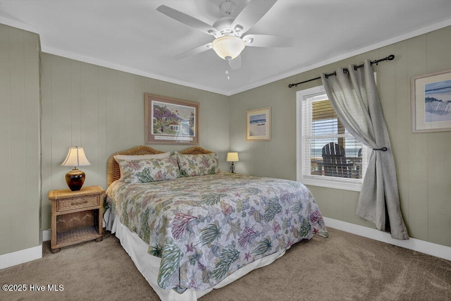 carpeted bedroom featuring ceiling fan and crown molding