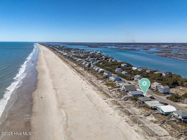 drone / aerial view featuring a beach view and a water view