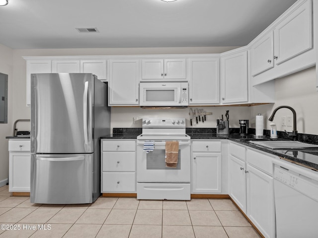 kitchen with visible vents, light tile patterned flooring, white appliances, white cabinetry, and a sink