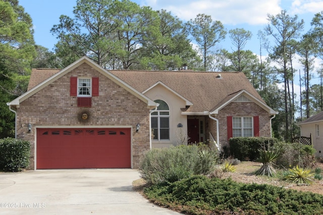 view of front of house with concrete driveway, brick siding, and a shingled roof