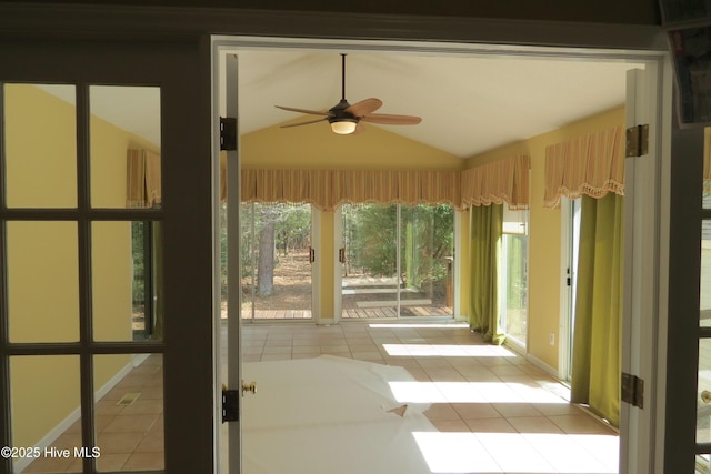 unfurnished sunroom featuring a ceiling fan and lofted ceiling