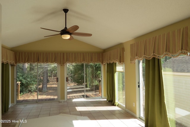 unfurnished sunroom featuring ceiling fan and lofted ceiling