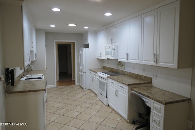 kitchen with recessed lighting, light tile patterned flooring, white cabinets, white appliances, and a sink