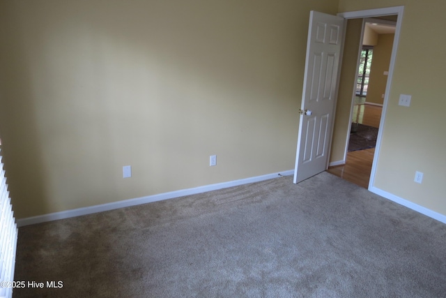 unfurnished room featuring baseboards and carpet floors