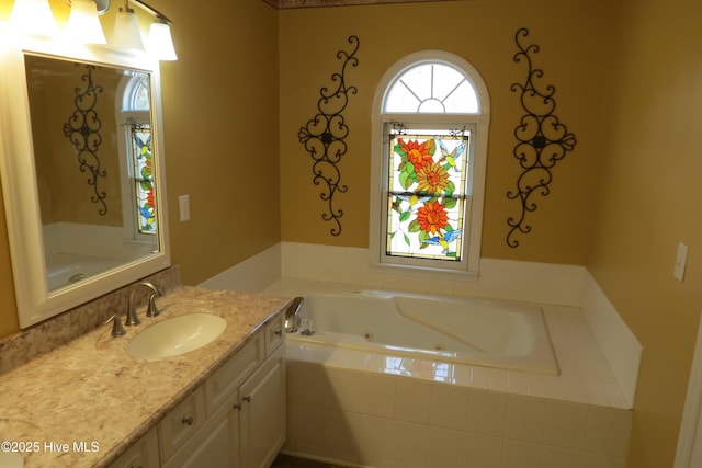 full bathroom with a jetted tub and vanity