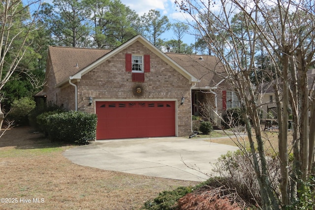 view of front of property with concrete driveway, a front yard, a shingled roof, a garage, and brick siding