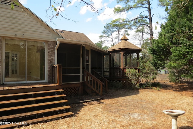 view of yard featuring a gazebo and a sunroom