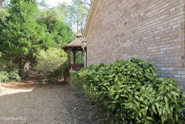 view of side of home with brick siding