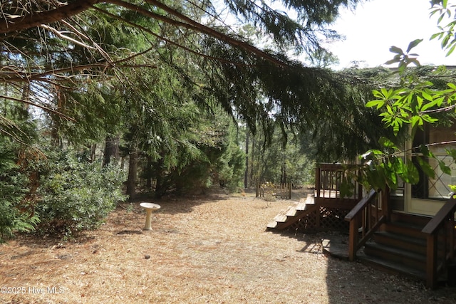 view of yard with stairway and a deck