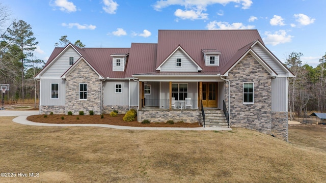 craftsman inspired home featuring a front lawn, covered porch, stone siding, and metal roof