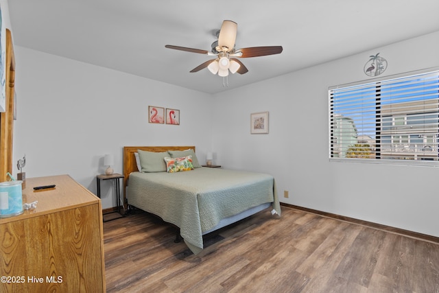 bedroom with wood finished floors, baseboards, and ceiling fan