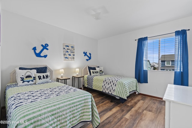 bedroom with baseboards and wood finished floors