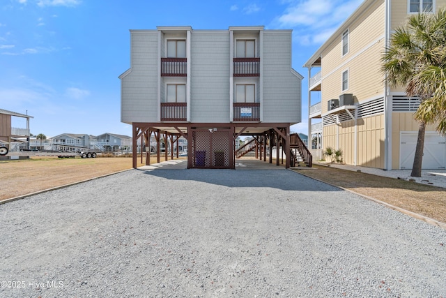 exterior space featuring a carport, stairway, and driveway