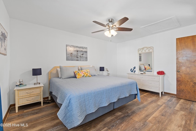 bedroom featuring ceiling fan, attic access, baseboards, and wood finished floors