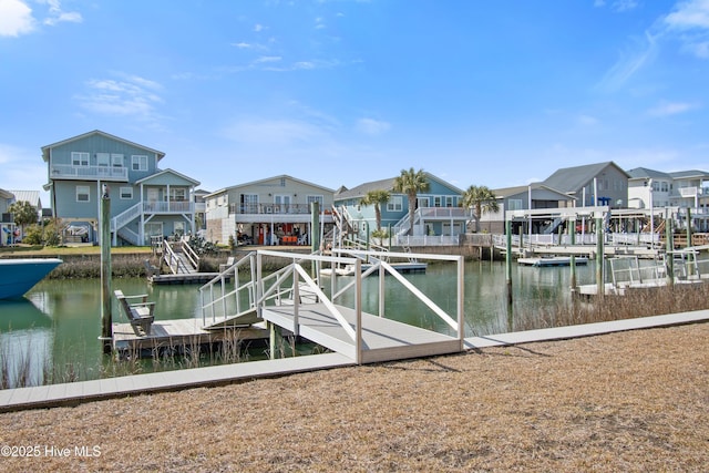 dock area with a residential view and a water view