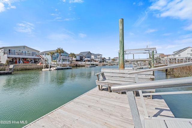 view of dock featuring a water view and a residential view