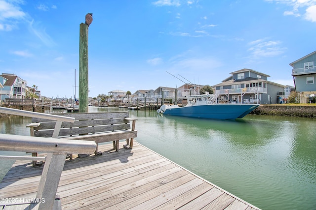 dock area featuring a residential view and a water view