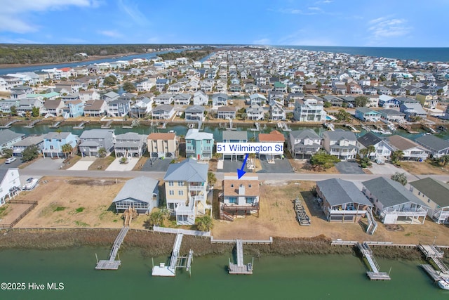 drone / aerial view featuring a residential view and a water view