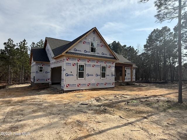 exterior space featuring an attached garage and dirt driveway