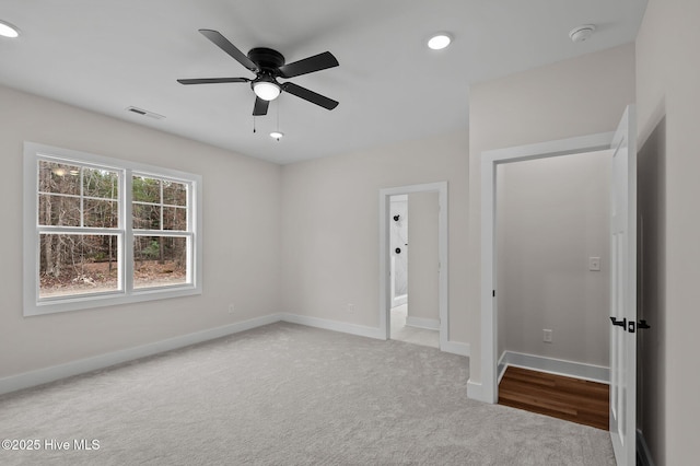 unfurnished bedroom featuring carpet flooring, baseboards, visible vents, and ceiling fan