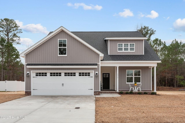 view of front of house featuring an attached garage, a shingled roof, fence, a porch, and driveway