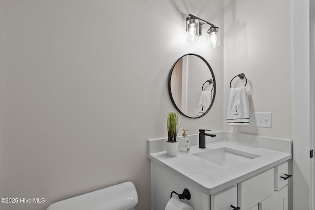 bathroom featuring toilet and vanity