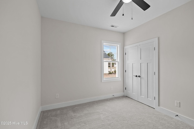 unfurnished bedroom with visible vents, light colored carpet, and baseboards