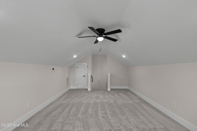 bonus room featuring visible vents, light carpet, baseboards, ceiling fan, and vaulted ceiling