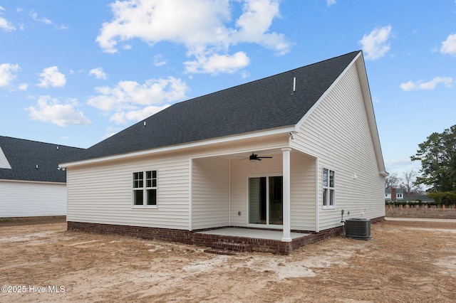 rear view of property featuring a patio area, cooling unit, a ceiling fan, and roof with shingles