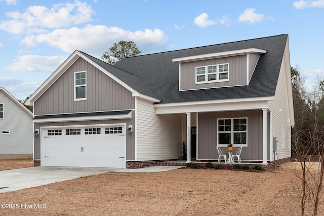 view of front of house featuring a garage, a porch, driveway, and a shingled roof