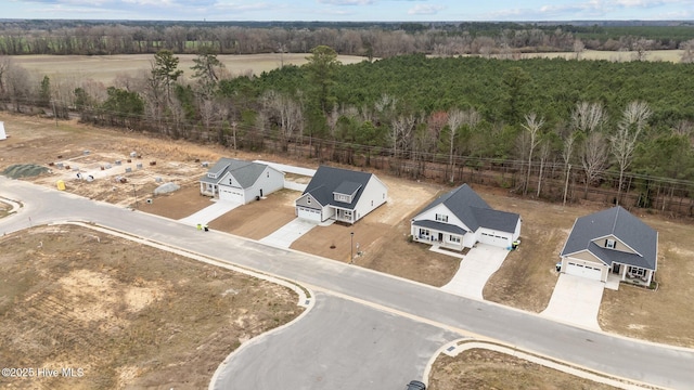 birds eye view of property with a wooded view